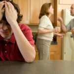picture of upset teen while parents argue